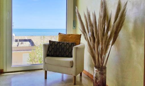 Bright living room with sea view and minimalist decor.