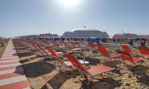 Beach with umbrellas and sunbeds under the sun.